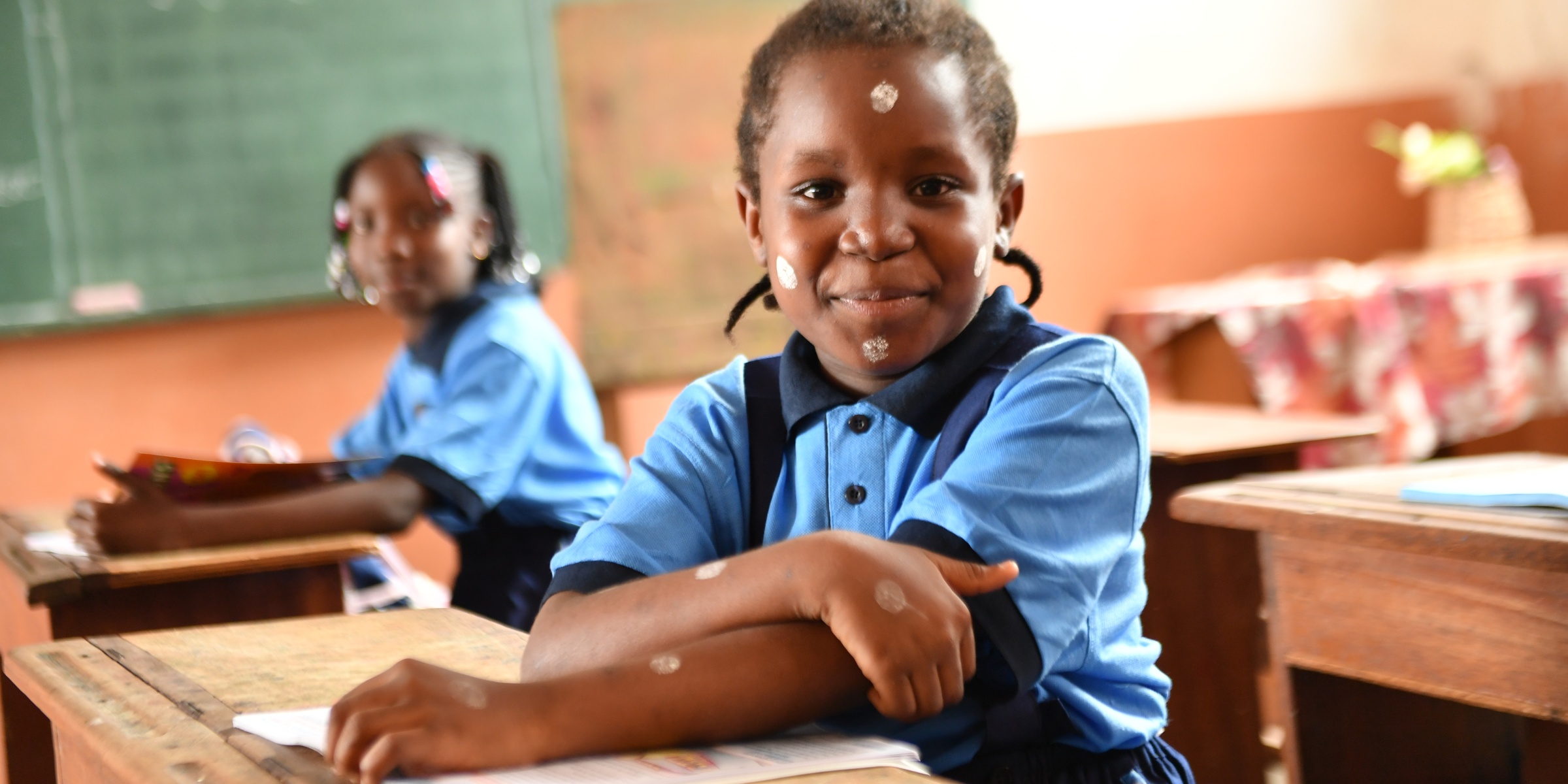 Girls sit in a classroom preparing for a class in Cameroon. September 2022. Credit: UNICEF/UN0704362/Beguel
